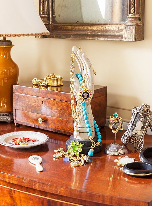 Elizabeth’s own designs on the bedroom vanity. She says her jewelry has a sort of neoclassical design sensibility and often feature micro mosaics.
