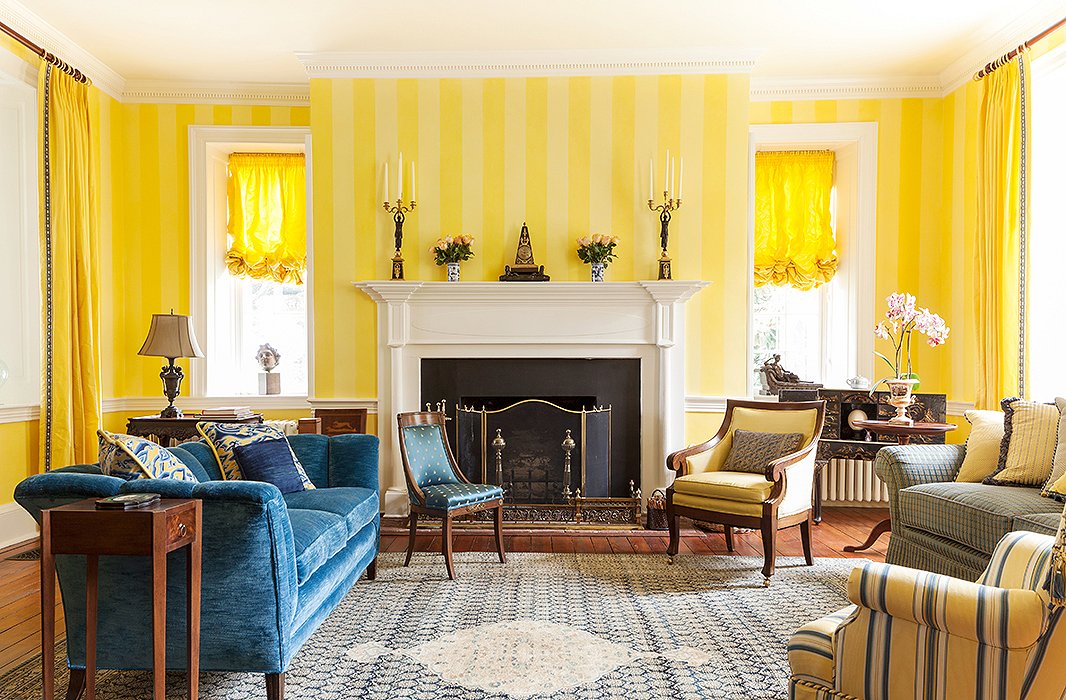 Now that it’s filled with yellows (and blues to balance the palette), everyone flocks to the sitting room. Elizabeth often ends up here with a magazine when she has a window of time to herself. Find a similar channel-back sofa here.
