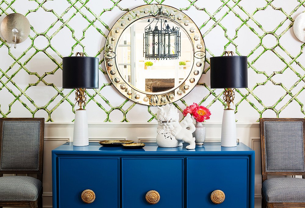 This bright, cheery room does lighting right: Twin lamps and sconces help soften overhead lighting.
