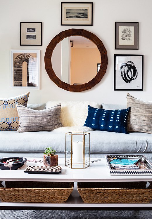 Here, the wooden round mirror is just another part of the gallery wall. Photo by Nicole LaMotte.
