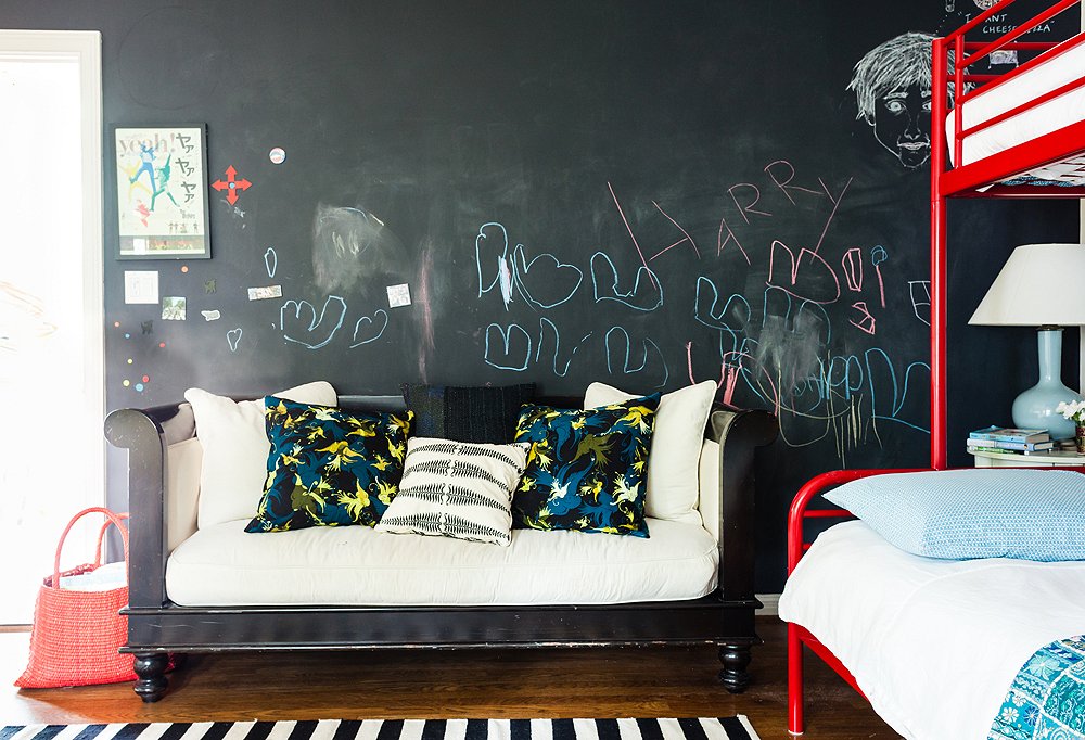 Kids’ rooms don’t have to be filled with kids’ furniture, as evidenced by eight-year-old Harry’s space, which holds a wood couch that will look just as appropriate 10 years down the road.
