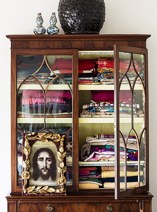 This inherited glass-front armoire has followed Lulu from home to home. “It holds everything extra in my life—mostly antique textiles from my travels through Turkey, Peru, India, and South Africa.”
