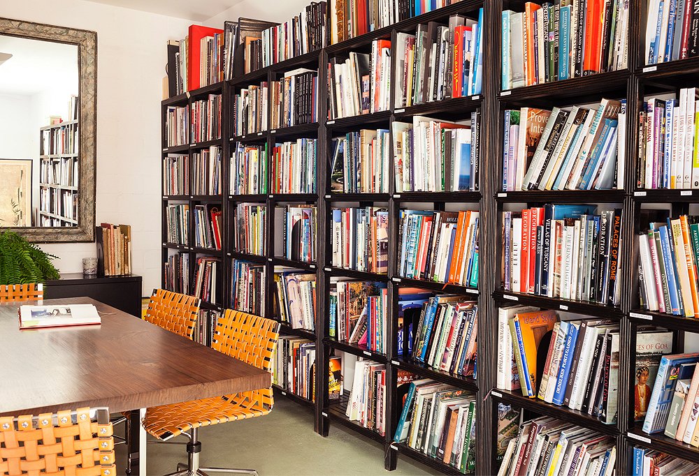 The office has a dedicated design-book library, where titles are organized by designer, architect, style, or region.
