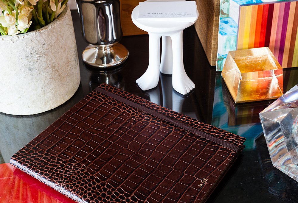 A crocodile Smythson notebook with Smith’s initials is used for jotting down appointments and notes, while a mini John Dickinson table keeps business cards easily accessible.
