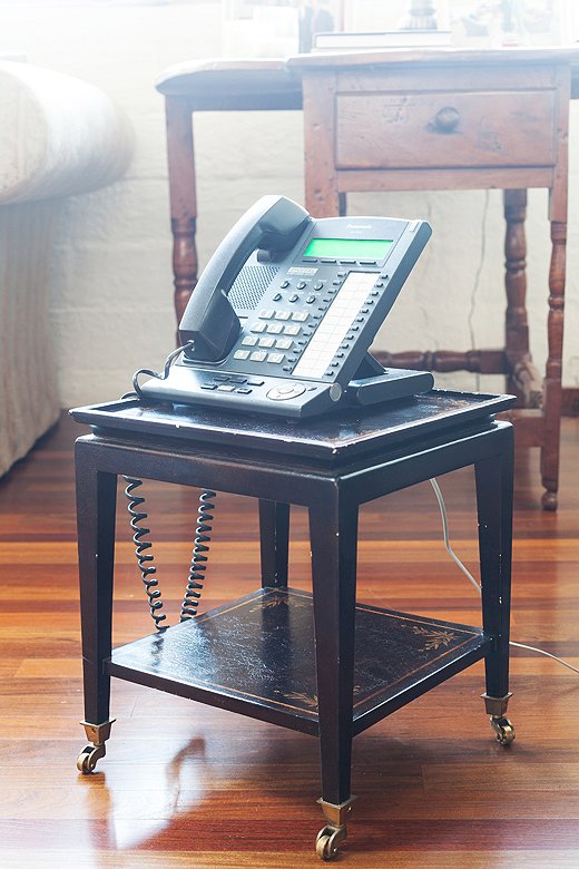Smith’s office phone sits atop an antique telephone table to ensure it can keep up with his swiveling from computer to conference table throughout the day.
