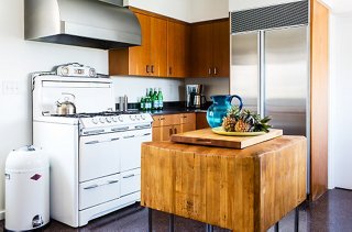 The oven is original to the 1930s home, but the wooden block island made a long trip from Brooklyn. “A butcher retired here and sold it to a local shop,” says Trina. “I love the way it’s contoured from all the years of use. It’s sculptural.”
