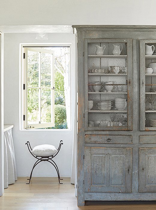 The pair take frequent trips to Europe to source the antique furniture they love. In lieu of built-ins, Brooke uses an antique French cabinet for silverware and dishes. “I tend to stick with white,” she says.
