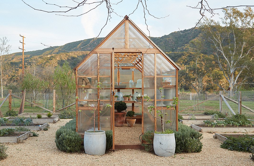 Gardens and animals were always part of the plan. “We envisioned eating our chickens’ fresh eggs and cooking with the vegetables and fruits we would grow,” says Brooke. The prefabricated greenhouse has shelves to protect delicate plants and start seedlings. A miniature hedge of rosemary grows around the perimeter.
