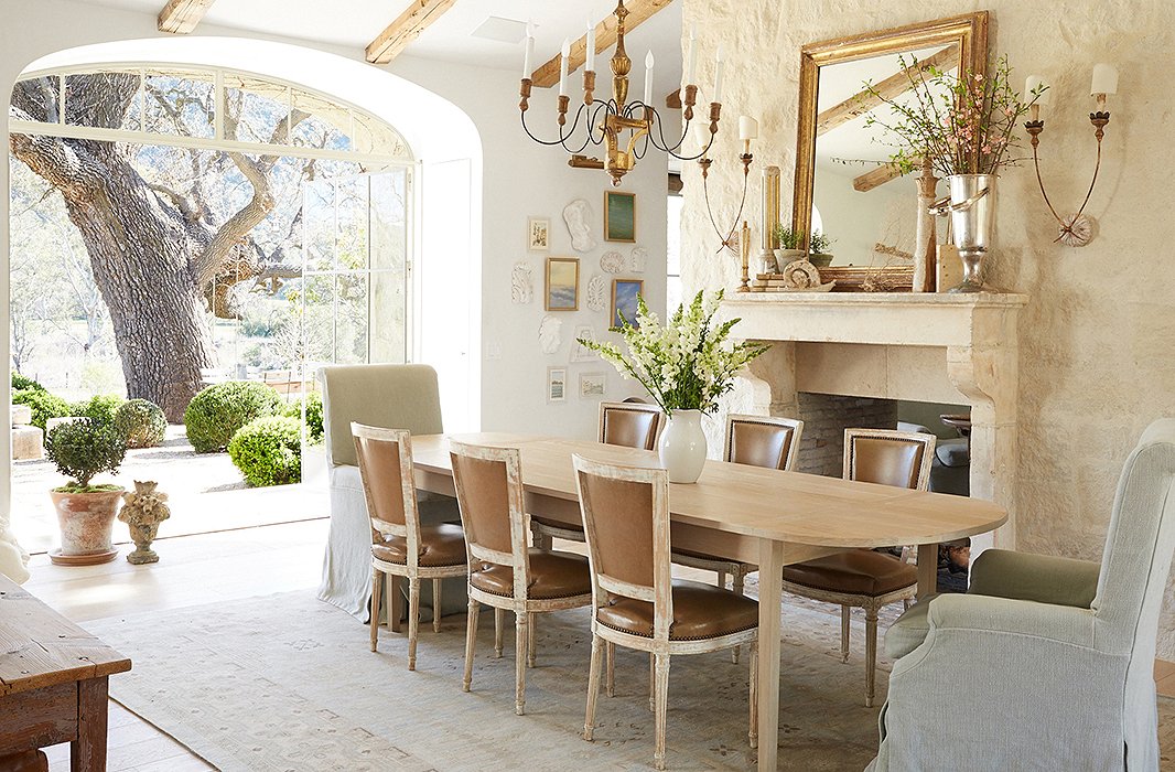 Knowing that they wouldn’t use a formal dining room, the couple created a flexible space. “We use it for meetings, school projects, and of course family meals,” says Brooke. Antique side chairs are paired with Giannetti Home armchairs.
