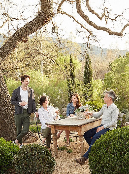 Brooke and Steve relax with two of their children in the alfresco dining area. “We wanted the outdoor spaces to be real rooms, an extension of what is inside the home,” says Brooke.
