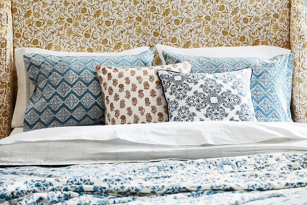 A tight palette and a common inspiration—Indian block prints—make this bedroom vignette serene rather than distracting. The Aurora Headboard in Vine Botanical Ochre is exclusive to One Kings Lane. 
