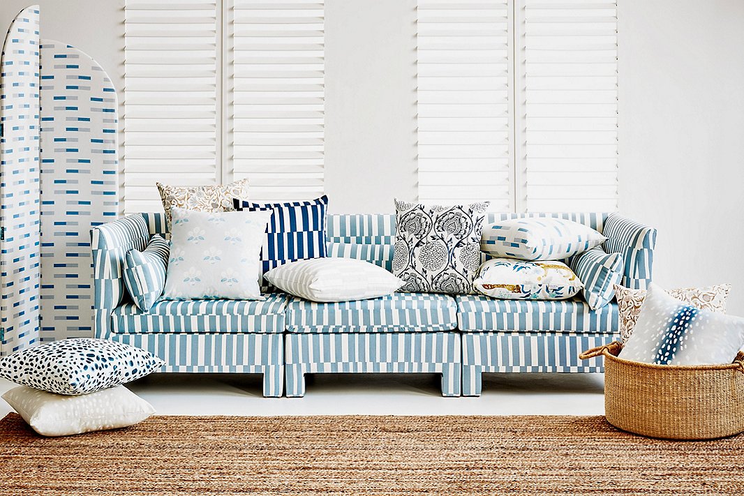 Blues and whites add cohesiveness to this mélange of patterns. Complementing the Sidney Room Screen in Nigel Chambray and the Bryn Sofa in Jump Stripe Chambray, both of which are One Kings Lane exclusives, are a variety of exclusive pillows.  
