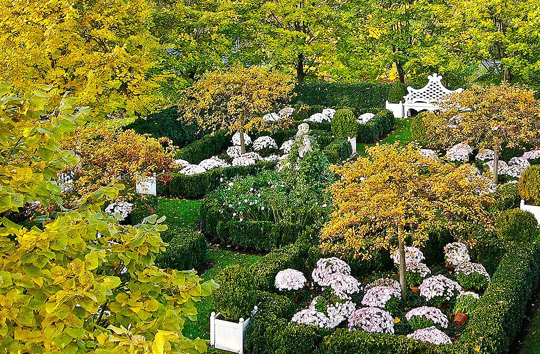 The grounds include a parterre garden (shown here in a photograph from At Home in the Garden). “Until I made my first trip to Europe, the term formal garden was to me an oxymoron,” Carolyne says. “Gardens were places where you ate tomatoes off the vine with one hand and pulled up carrots with the other.”
