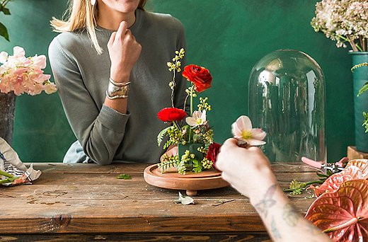 “You want the flowers to be facing in different directions,” says Michael. He suggests working in odd numbers—like these three red roses.
