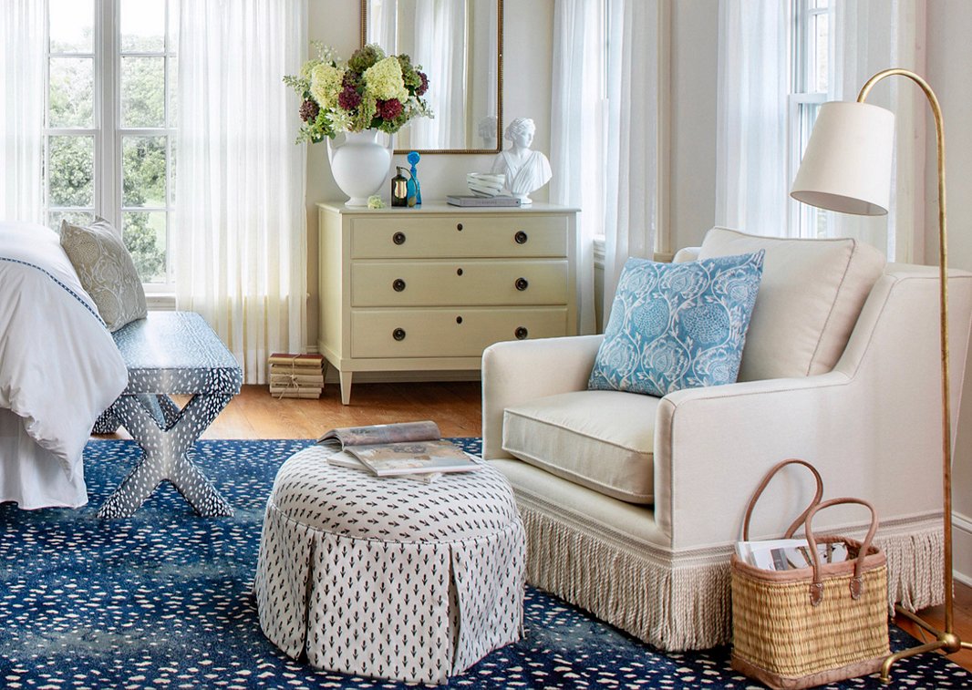 The cozy charm of the Liza Skirted Ottoman in Floral Ink and the Portsmouth Chair in Cream Linen prevents the animal prints of the bench and the rug from making the room feel too glam.
