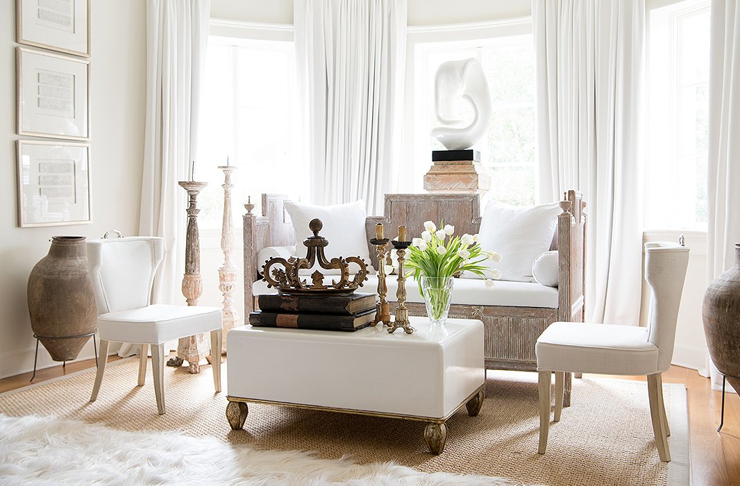“When I painted this room, I’d fallen in love with Benjamin Moore’s Linen White, and I loved how that looked with the white resin sculpture,” Tara says of the master bedroom’s sitting area. Tara layered more white from there: drapes, a 22-ounce linen on the banquette, more Linen White in a high gloss on the coffee table.
