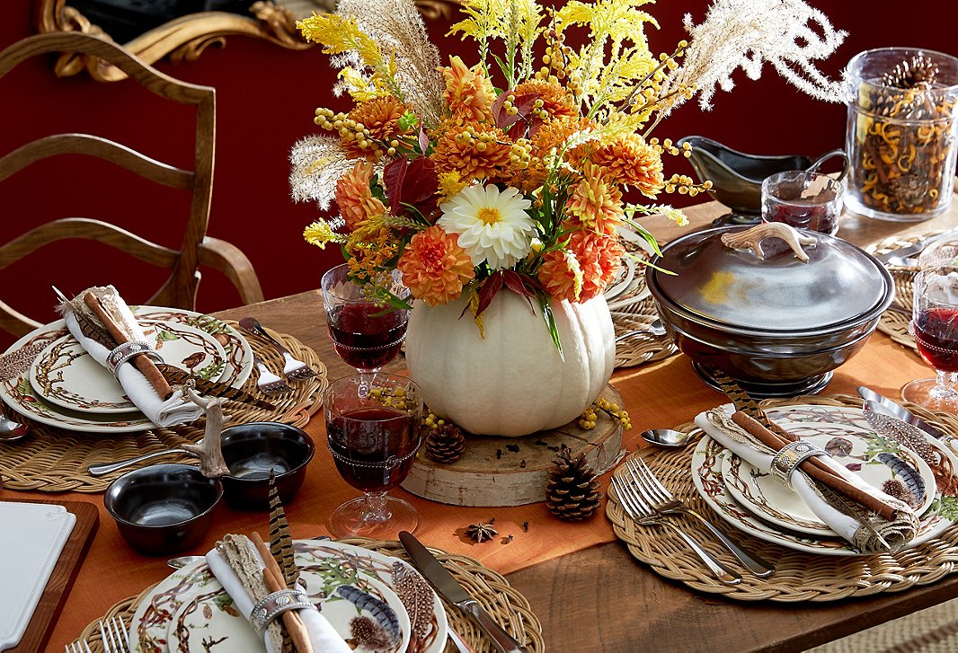 With its whimsical woodland motifs, Juliska’s Forest Walk dinnerware feels right at home on the Thanksgiving table. Hollow out a white pumpkin and place a floral arrangement inside for a finishing flourish. 
